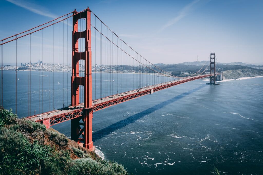 Iconic Golden Gate Bridge over San Francisco Bay under clear blue skies, showcasing its majestic structure.